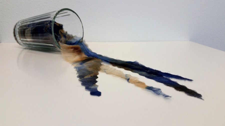 'Poisoning Flint' is made of hand-dyed, rust dyed silk organza, felted wool, stitch, and a drinking glass.  